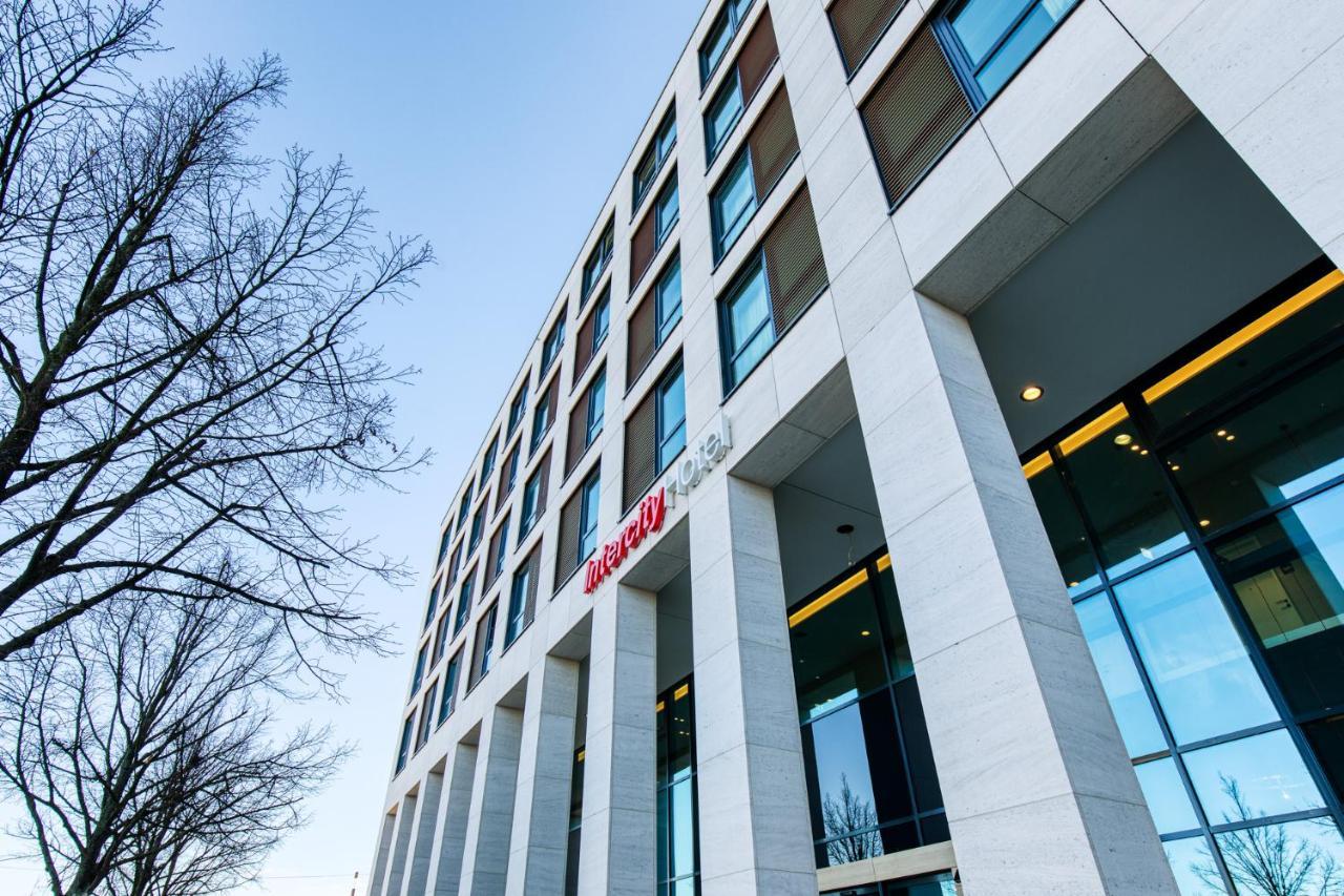 Intercityhotel Berlin Airport Ber Terminal 1 & 2 Schönefeld Εξωτερικό φωτογραφία The photo shows a modern building with a sleek, contemporary design. The structure features several large windows and a façade composed of light-colored stone. There is a visible entrance with glass doors, and the building appears to be several stori